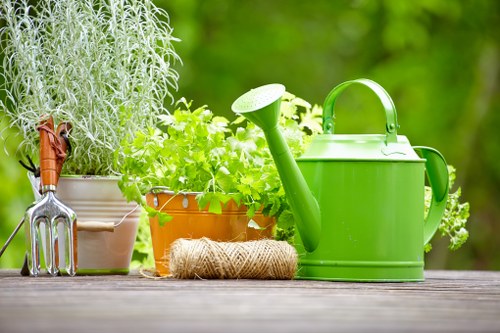 Gardener preparing to trim a hedge at a residential boundary